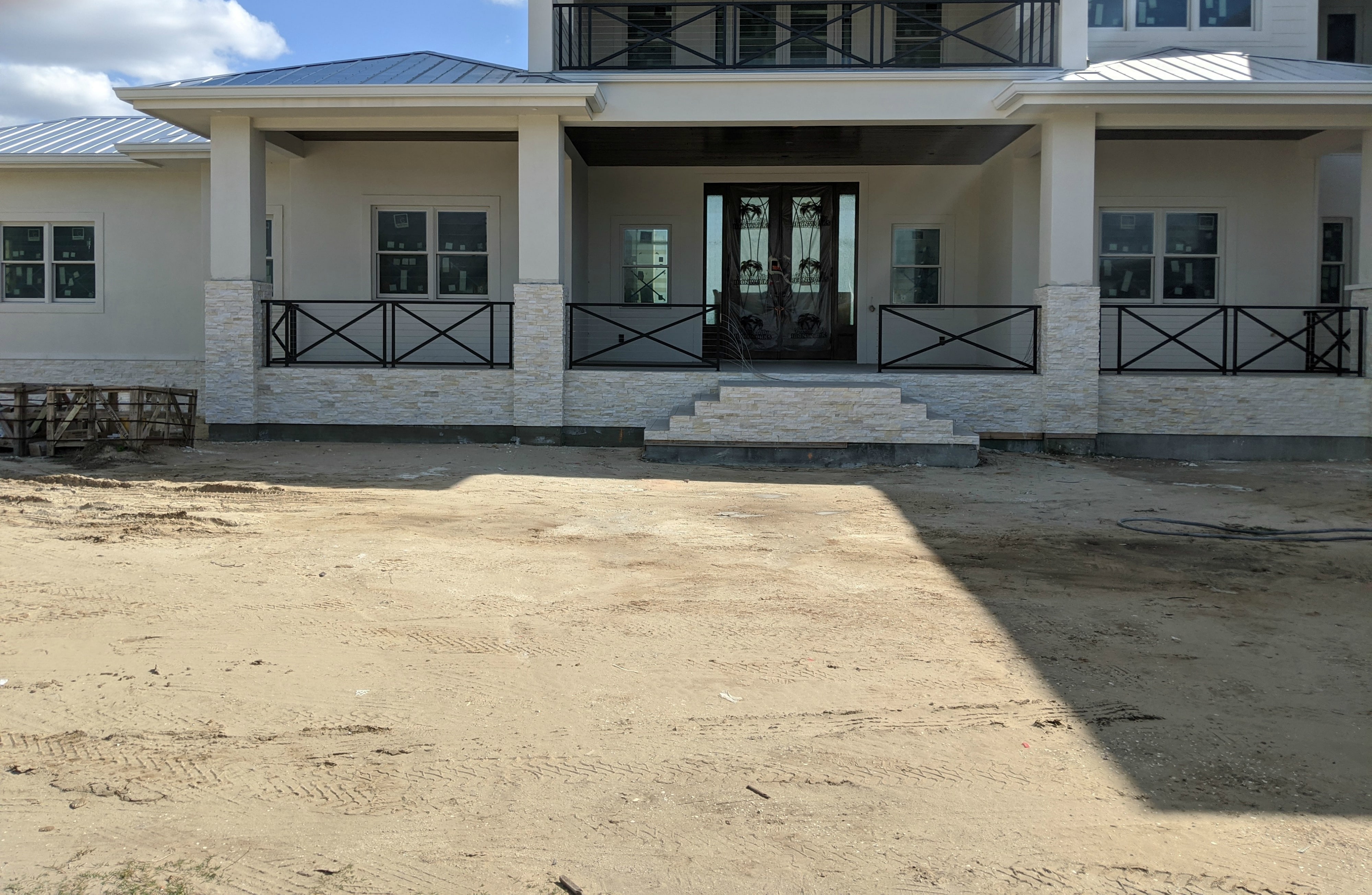 Profile of Norstone Ivory XLX Stacked Stone Veneer Panels as a Wainscoat on a Coastal Modern Home in Florida